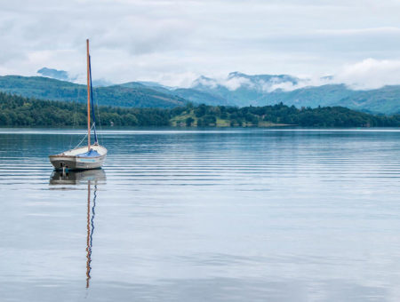 Boat on Lake Windermere with mountains in the background